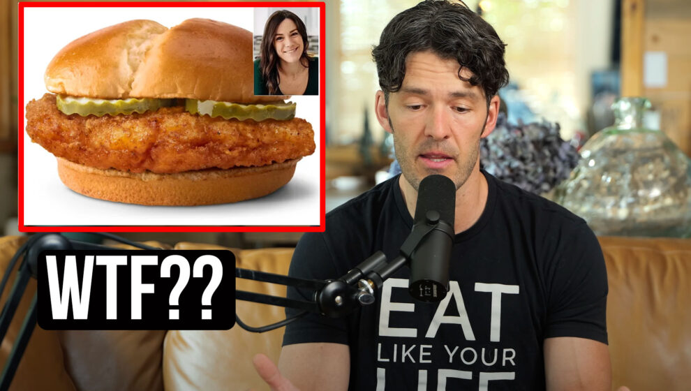 Mike is speaking into a microphone. An image of a dietician smiling next to a photo of a McDonald's fried chicken sandwich is to the left of the screen with "WTF??" written below it.