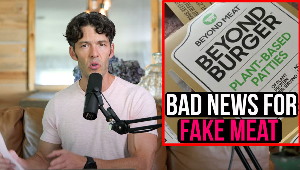 This image shows Mike Mutzel speaking into a microphone, pointing to a printed study. On the right of the screen is an image of "Beyond Burger" and below is written "Bad News for Fake Meat".